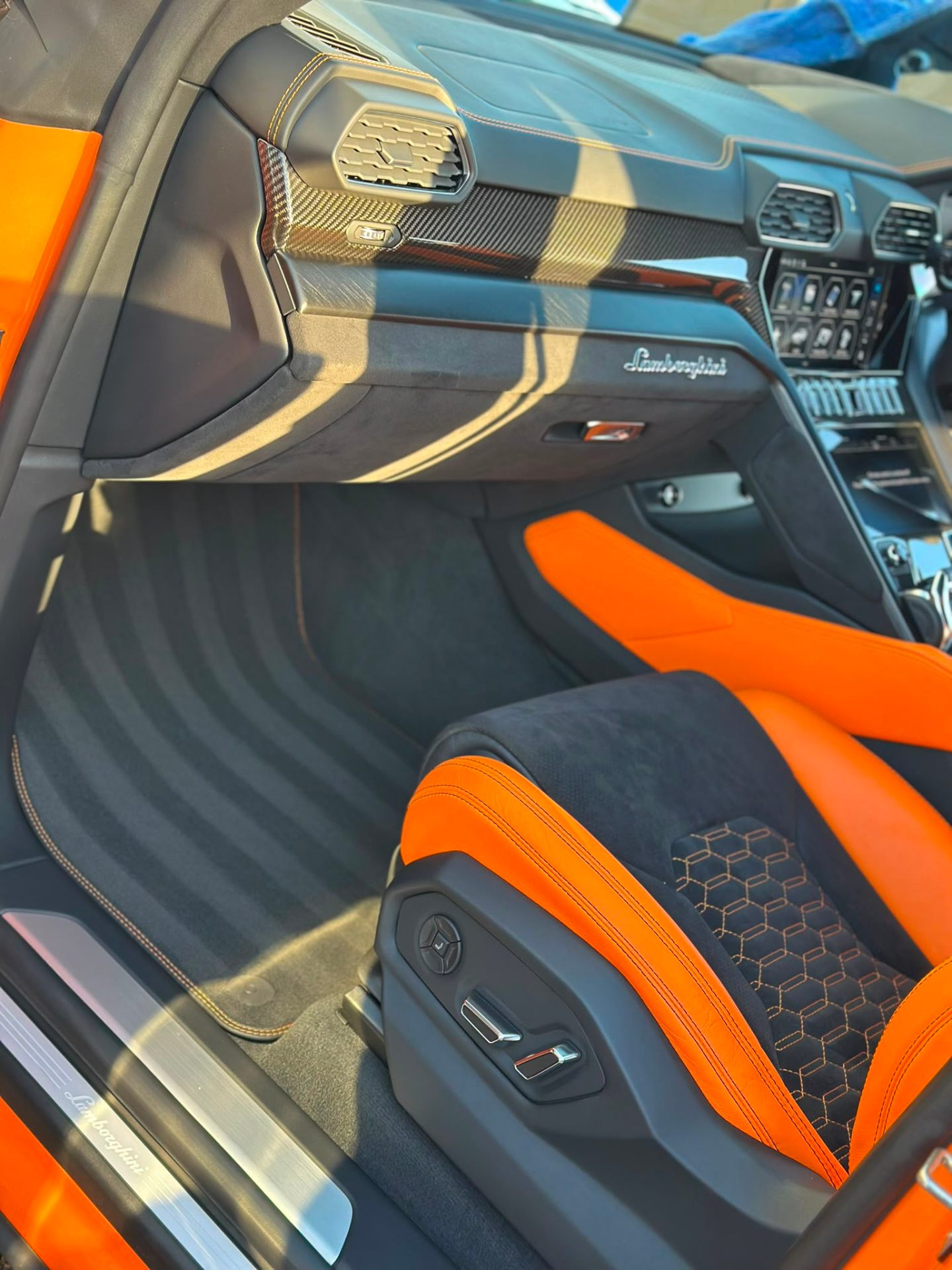 Lamborghini Urus interior with orange and black leather detailing